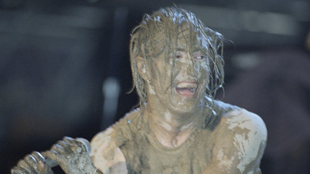 Trent Reznor covered in mud