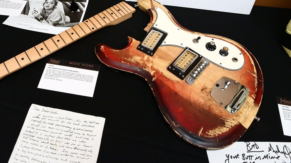 battered guitar on display