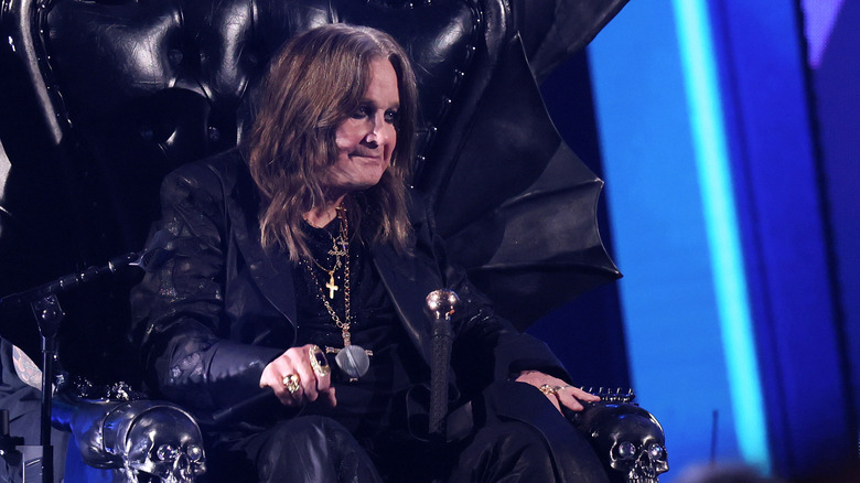 Ozzy Osbourne sitting on a throne at the Rock and Roll Hall of Fame induction ceremony