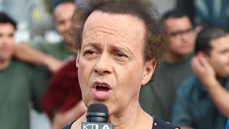 richard simmons holding microphone