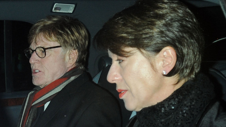 Robert Redford and Lola Van Wagenan in a car