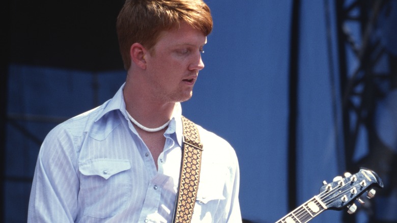 Josh Homme playing guitar