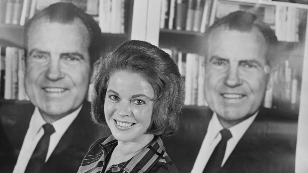 Shirley Temple (1928 - 2014) in front of a poster of Richard Nixon at a Republican Party election press conference at the Cafe Royal in London, UK, 13th September 1968.