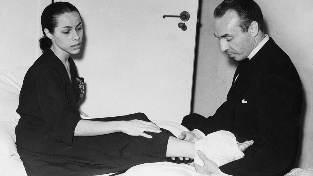 George Balanchine checks Maria Tallchief's ankle
