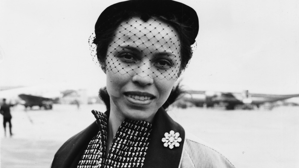 Maria Tallchief standing for a photo wearing hat with veil