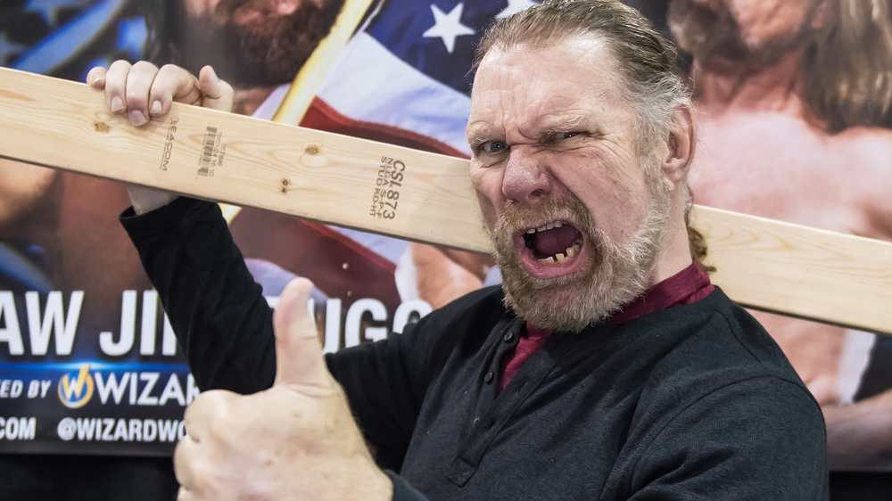 "Hacksaw" Jim Duggan holding a two-by-four