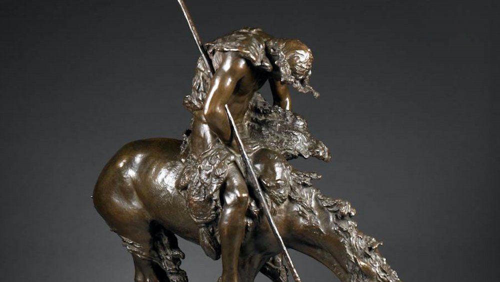 A bronze replica of Fraser's famous End of the Trail, depicting an Native American with a spear on a horse.