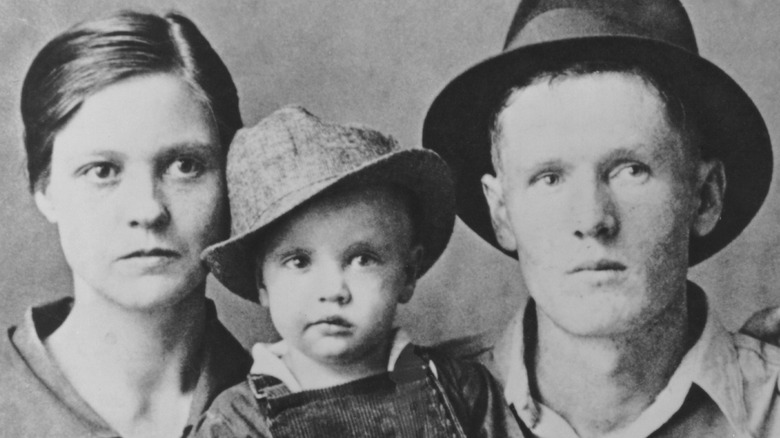 Gladys and Vernon Presley posing with 2-year-old Elvis