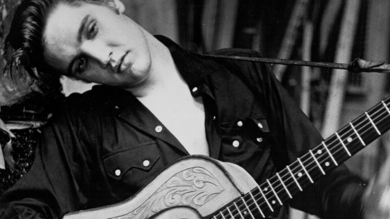 Elvis posing with guitar