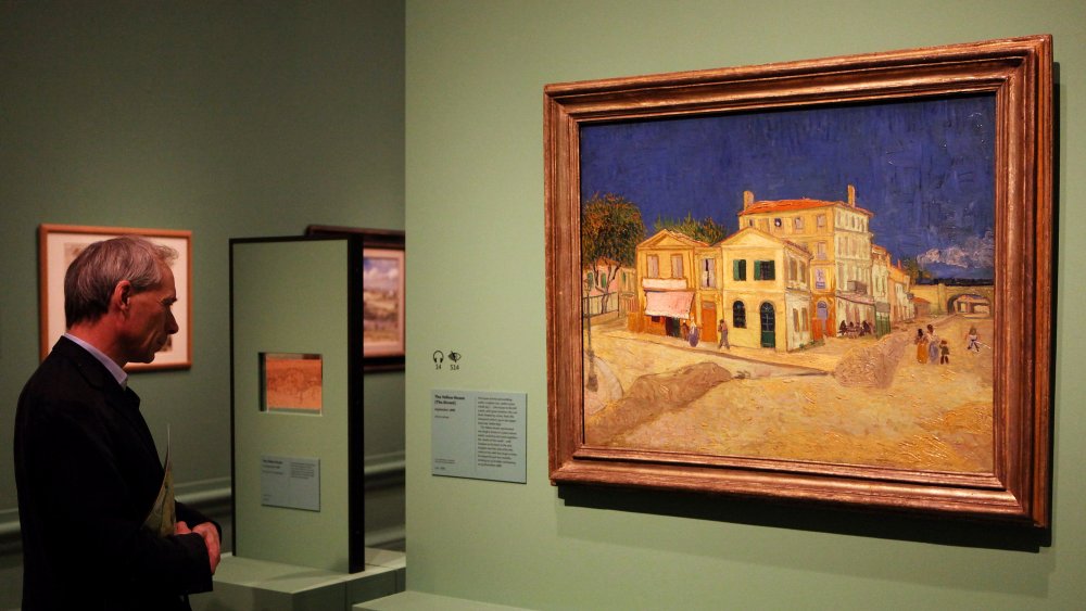 A man admires an oil painting by acclaimed Dutch artist Vincent Van Gogh entitled "The Yellow House (The Street)"