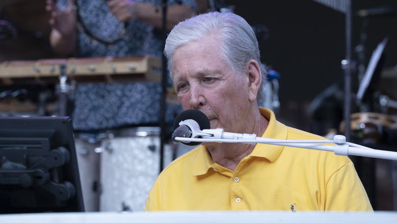 Brian Wilson at piano in yellow shirt