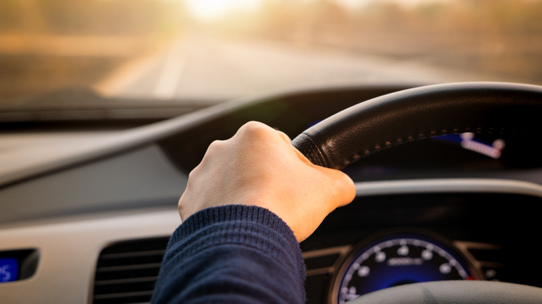 Hand on steering wheel