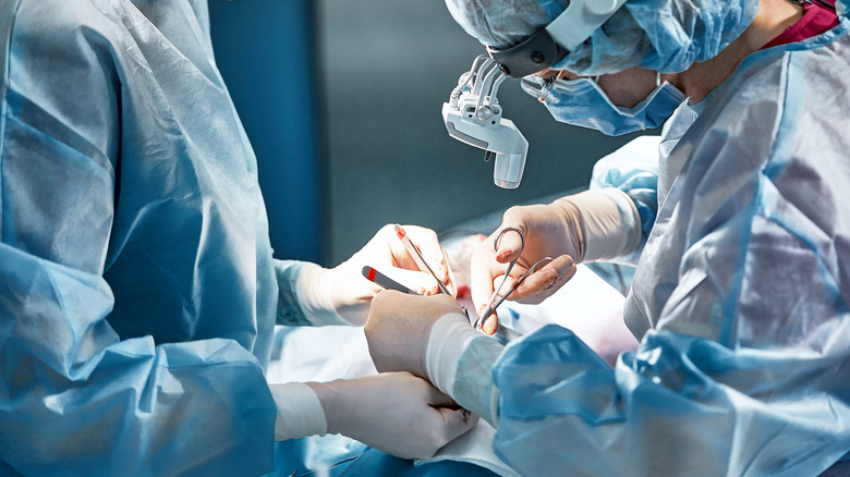 doctors performing surgery with tools