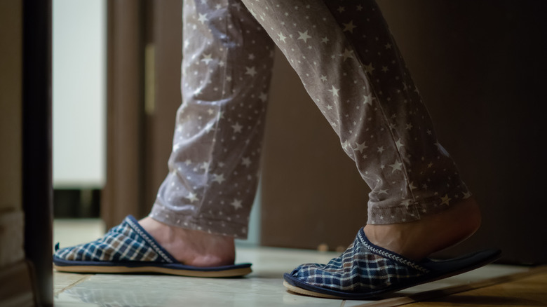 woman walking in pajamas at night