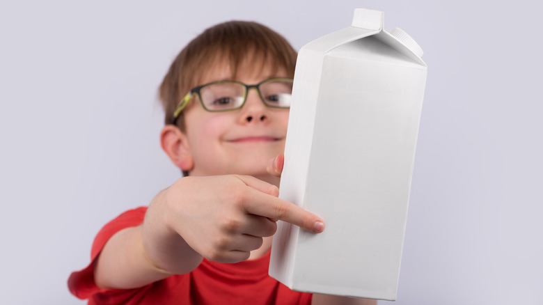 kid holding a milk carton