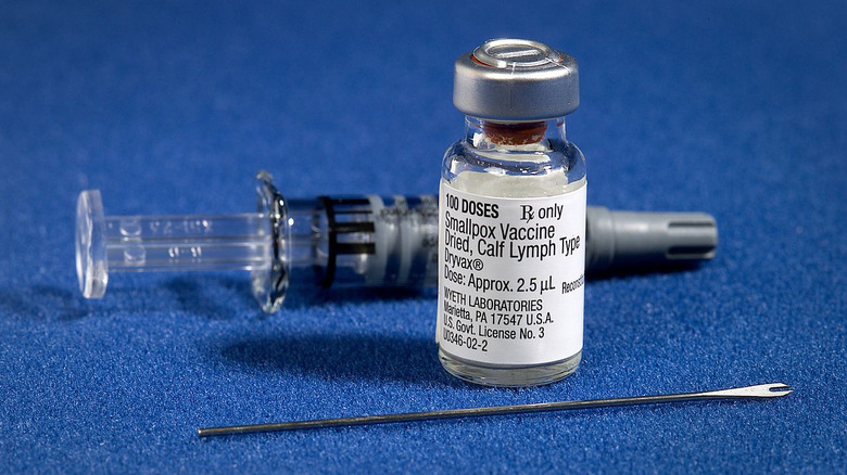 Parts of a smallpox vaccination kit, including vial and bifurcated vaccination needle