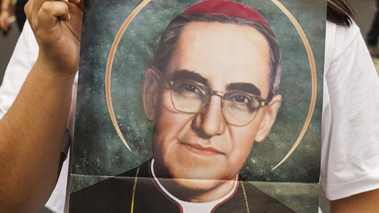 Woman holding picture of Saint Óscar Romero 