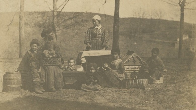 Enslaved women and children outside