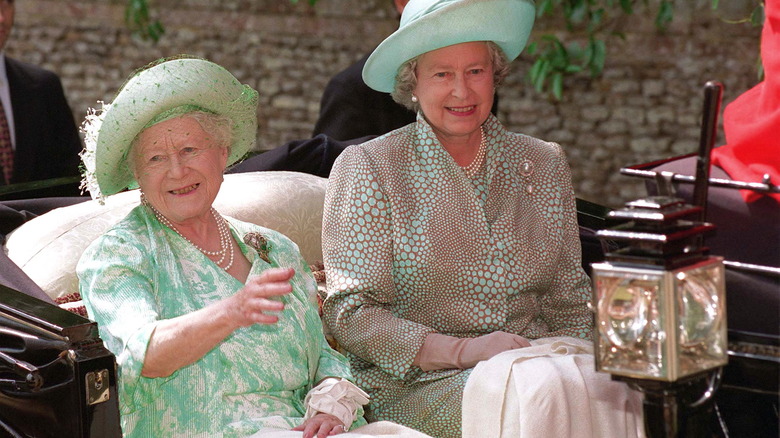 Queen Elizabeth and the Queen Mother riding in a car