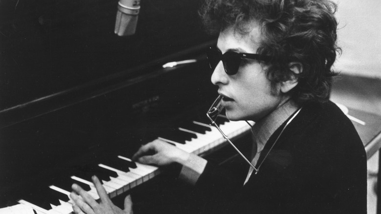 Bob Dylan at piano in sunglasses