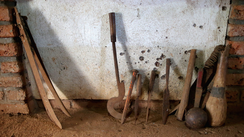 clubs, machetes, and spears against wall Rwandan genocide weapons display