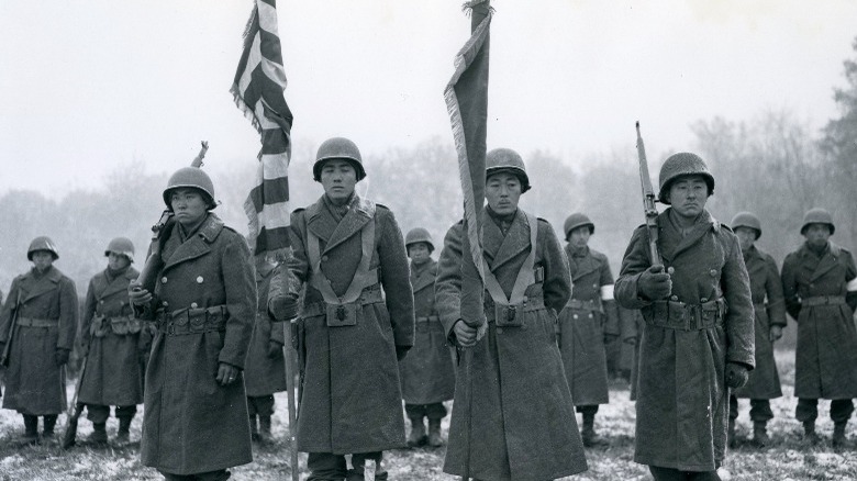 442nd troops holding flags