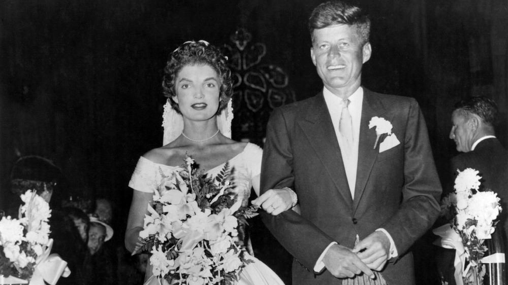 Jacqueline Bouvier and John F. Kennedy walking down aisle at their wedding