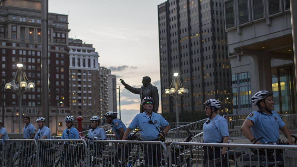 Police officers guard a statue of former Philadelphia mayor Frank Rizzo as protesters march against white supremacy August 16, 2017 in downtown Philadelphia, Pennsylvania. Detractors call the statue a symbol of white supremacy and want it taken down. Demonstrations are being held following clashes between white supremacists and counter-protestors in Charlottesville, Virginia over the weekend. 