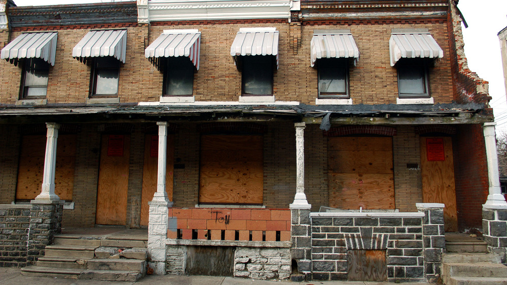 Boarded up vacant houses are seen near Peirce Elemantary School where Faheem Thomas-Childs was shot in a cross fire February 17, 2004 in Philadelphia, Pennsylvania. 