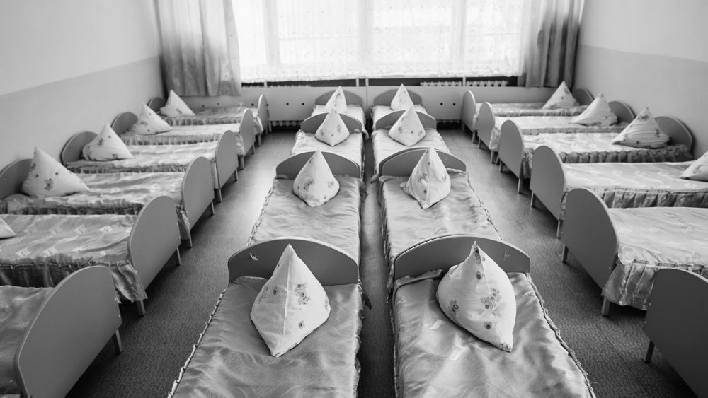 Cots in the kindergarten. Orphanage or boarding school.