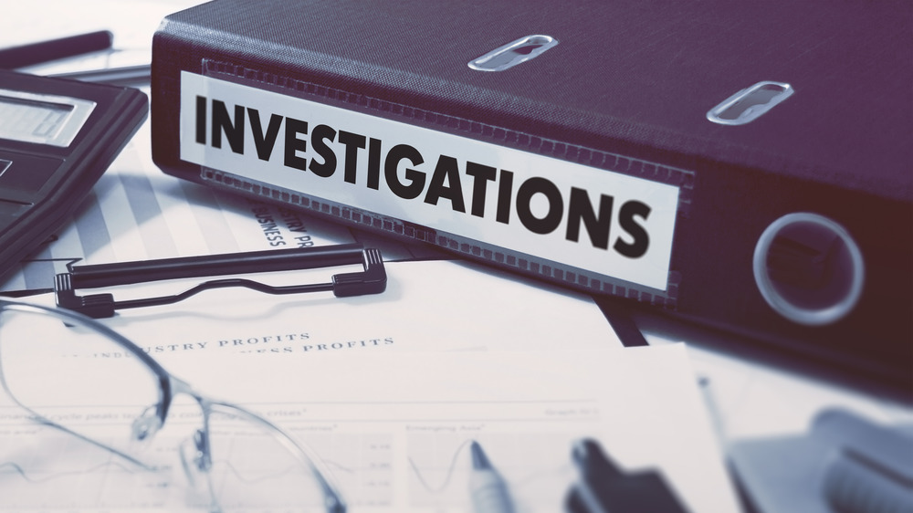 binder of investigations on a desk