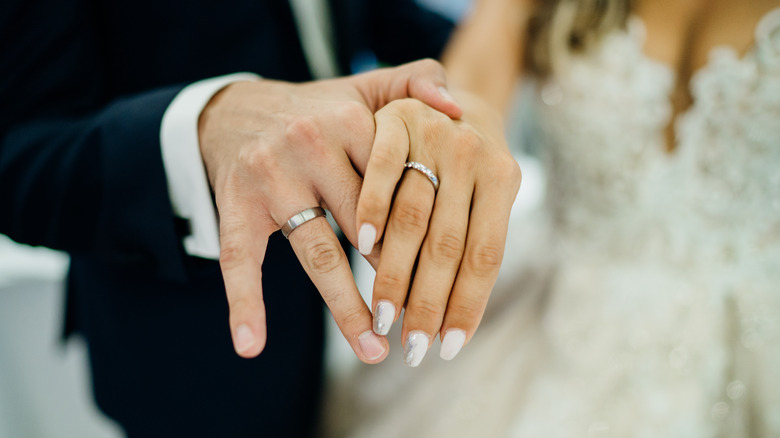 Bride and groom wearing wedding rings