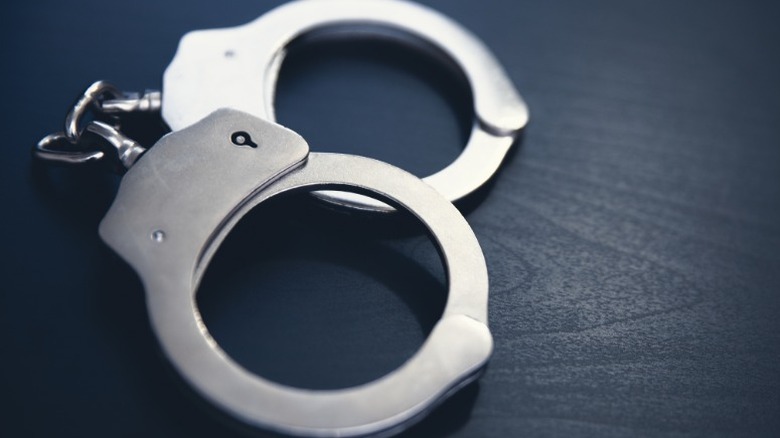 pair of police handcuffs on table