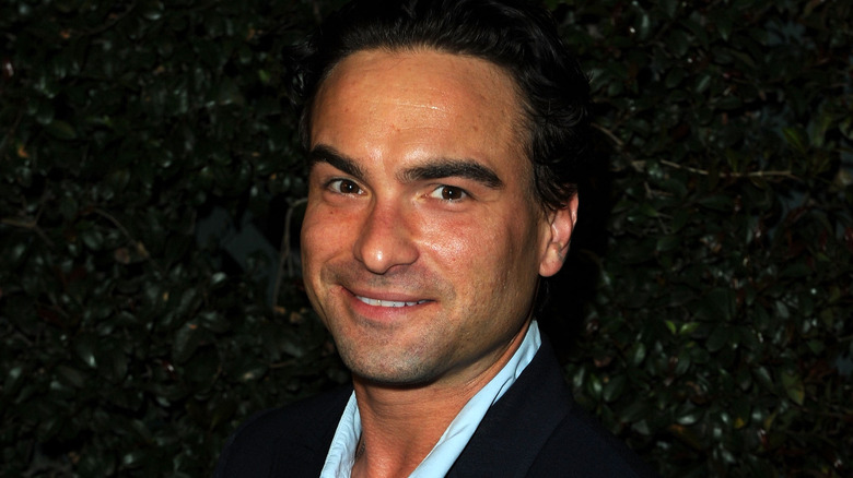 Smiling Johnny Galecki in front of a black background in 2010