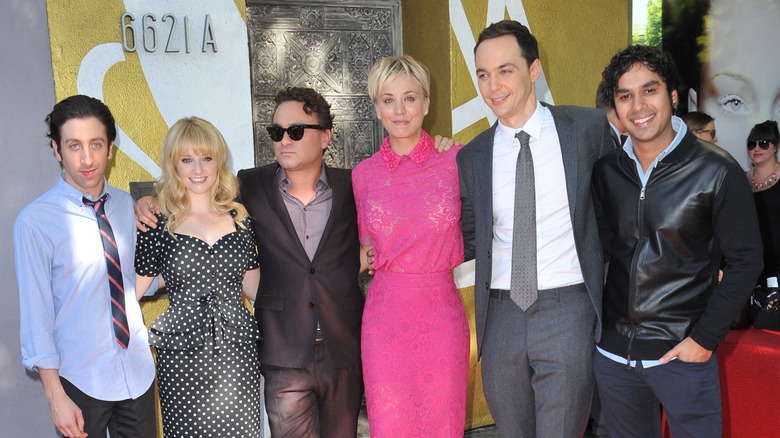 The cast of The Big Bang Theory poses for photo with arms around each other