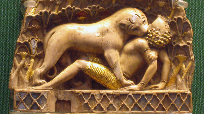 Nimrud ivory lion eating man golden