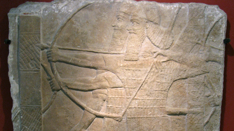 Assyrian warriors with bows stone relief