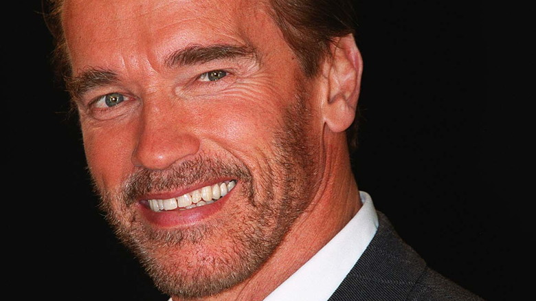 Arnold Schwarzenegger smiling in suit