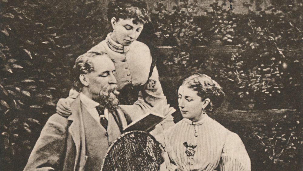 Charles Dickens reading to his daughters.