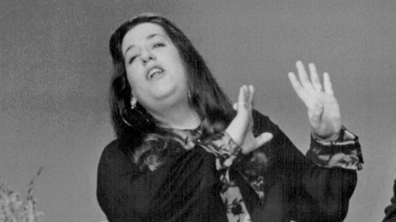 Cass Elliot waving arms mouth open