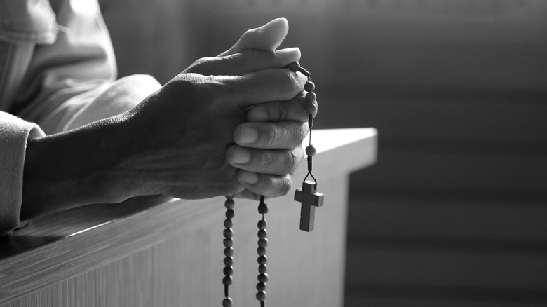 Man gripping rosary