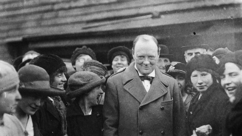 Winston Churchill in 1918, with female workers at a filing works in Glasgow