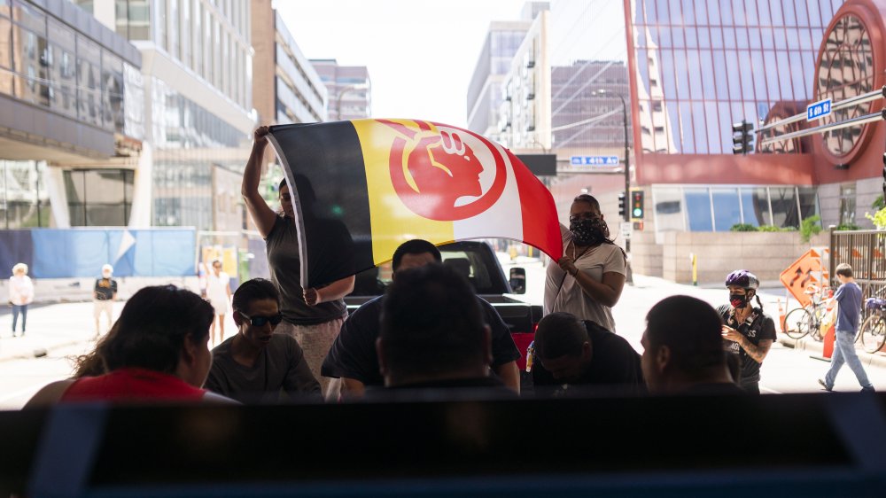 People holding up flag of American Indian Movement during George Floyd protests