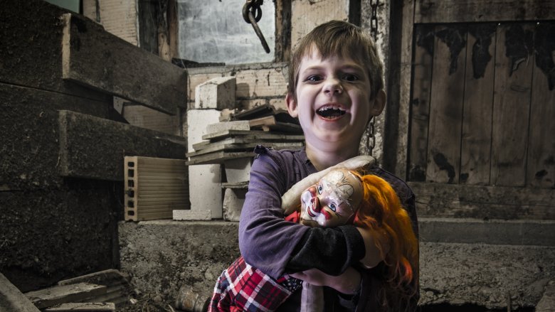 creepy boy with doll