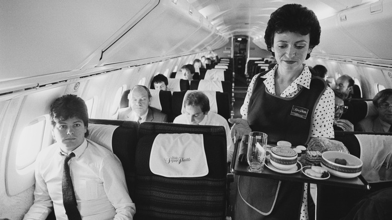 flight attendant serving refreshments