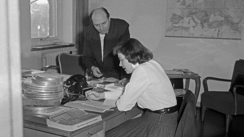 female secretary reading papers