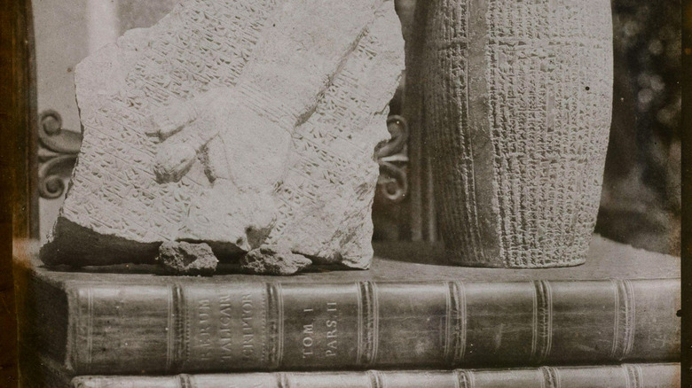 Still life with ancient Babylonian artifacts on books.