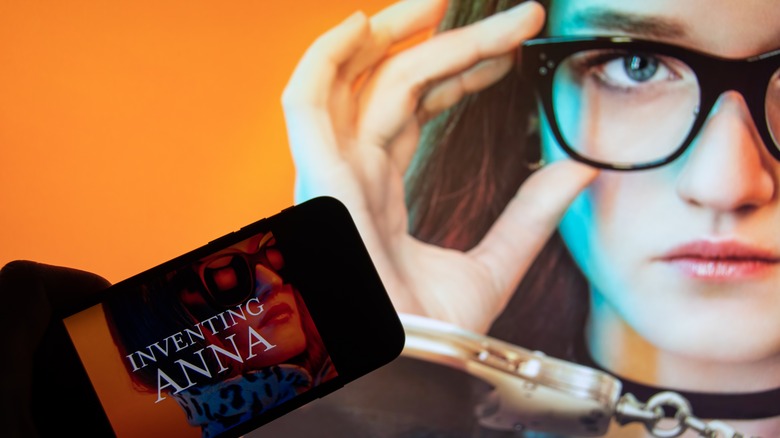  Anna Delvey Sorokin holding glasses