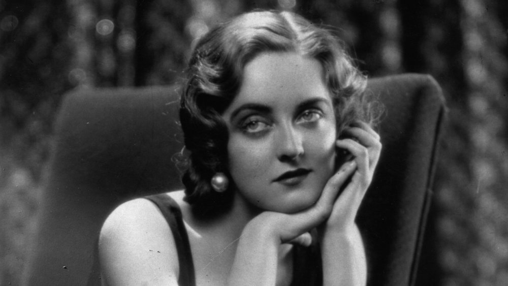 Bette Davis resting her hands on her chin