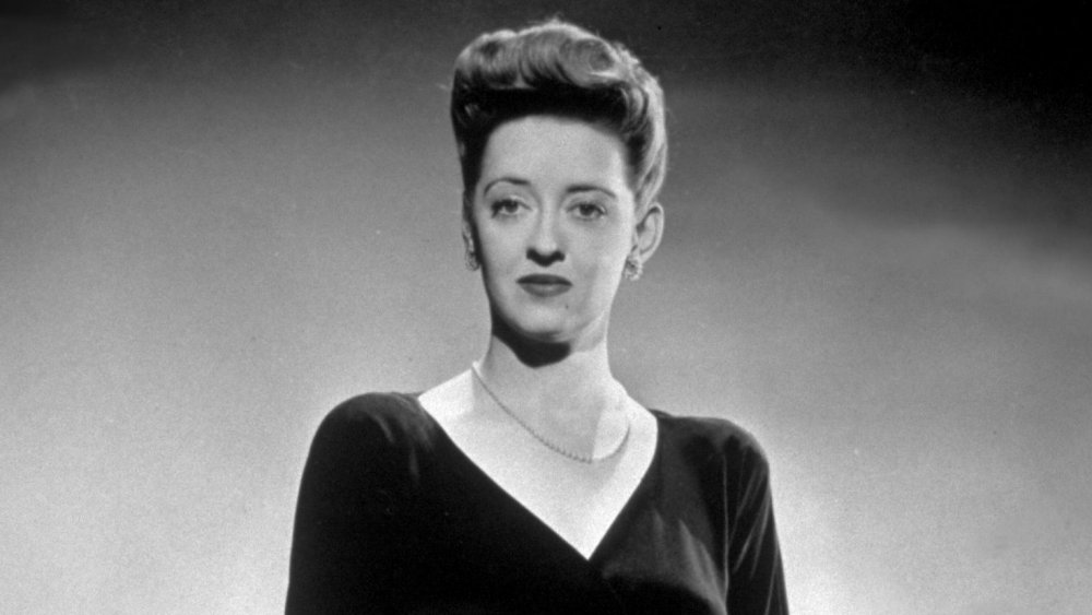 Bette Davis in a black dinner gown